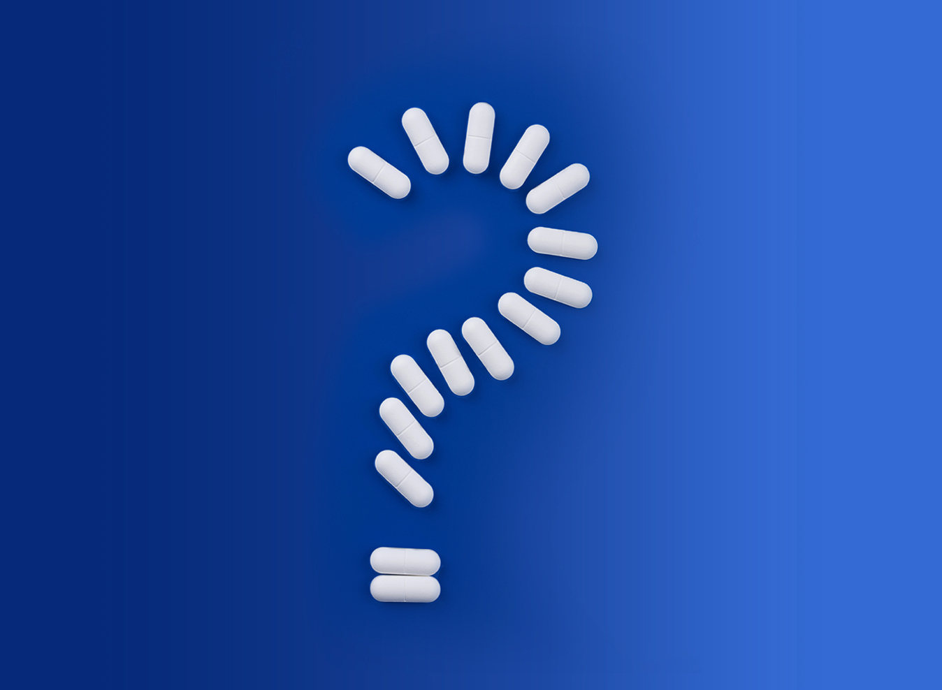 A question mark made from many white pills